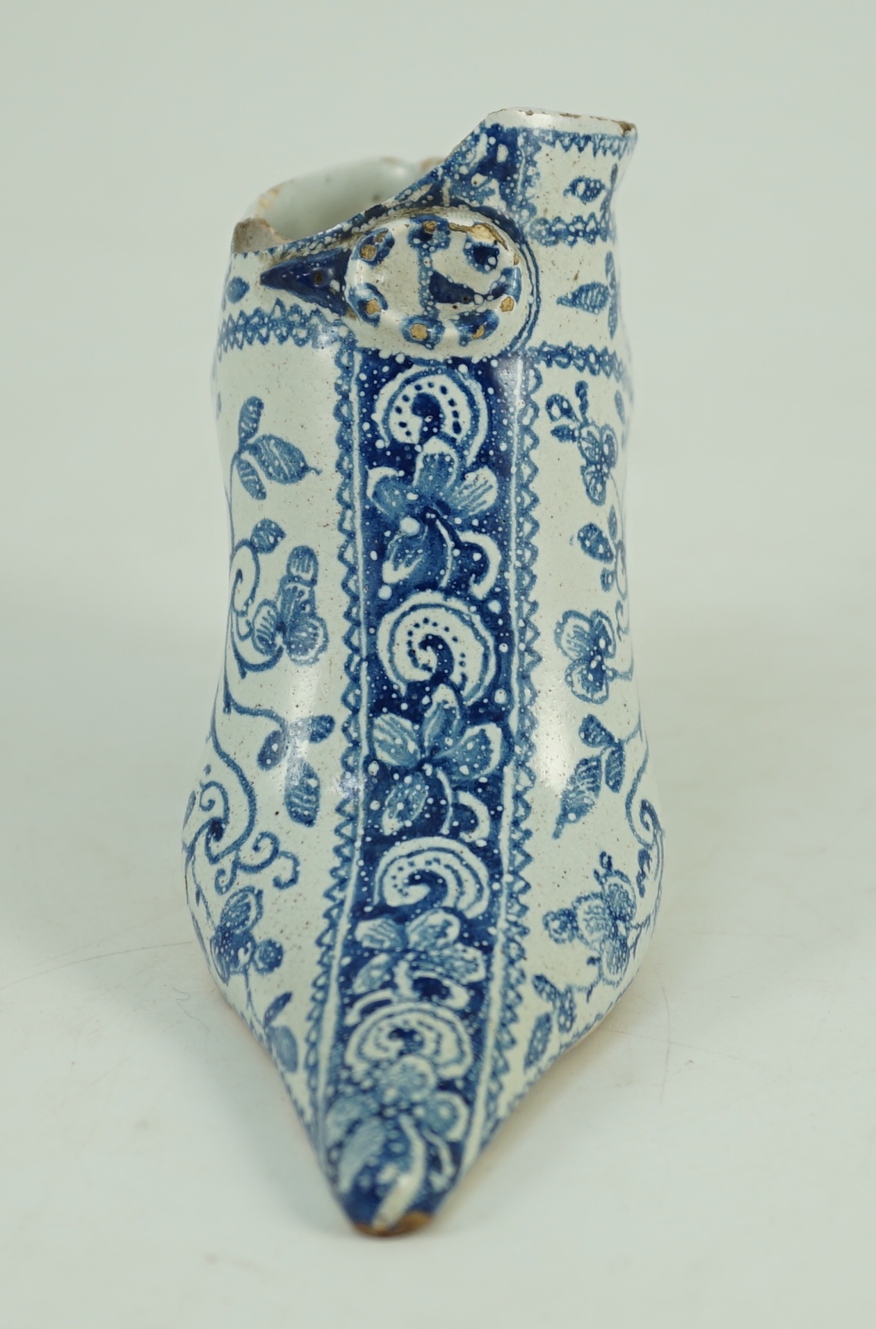 A documentary English delftware blue and white model of a shoe, dated 1732, 16cm long, damage